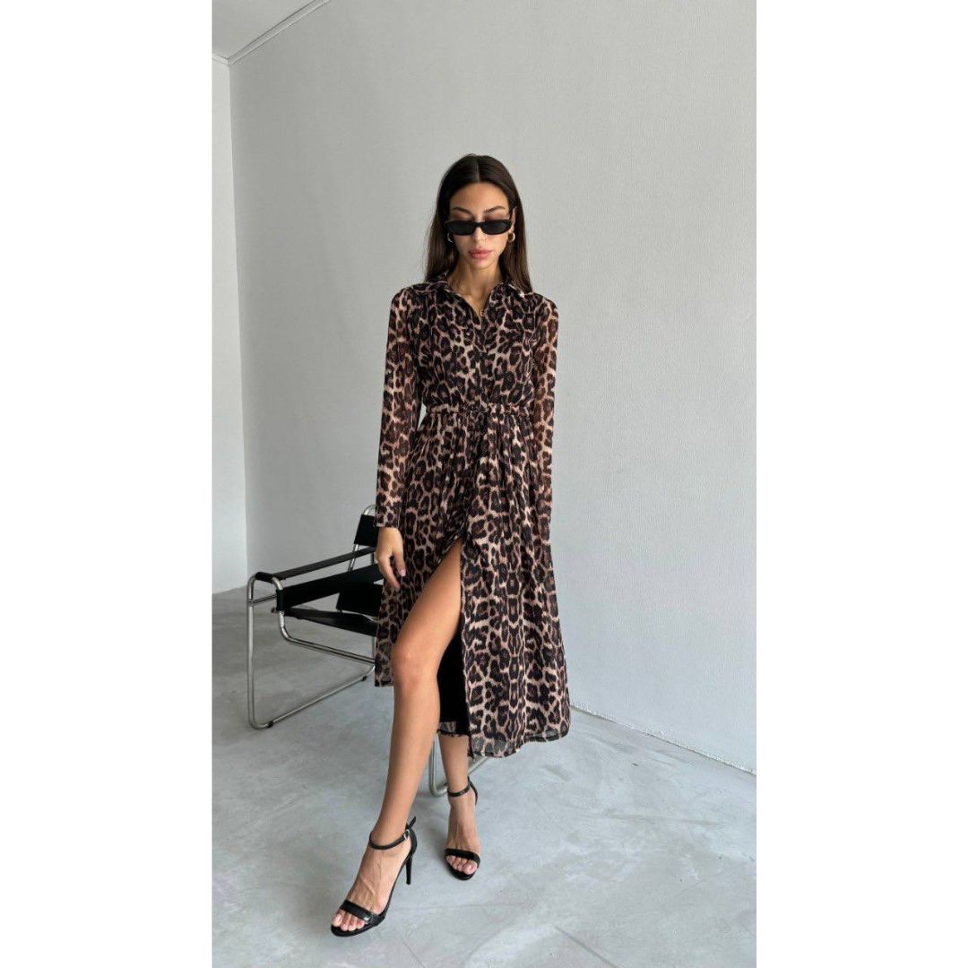 leopard print dress with a high slit, standing in a minimalistic room.